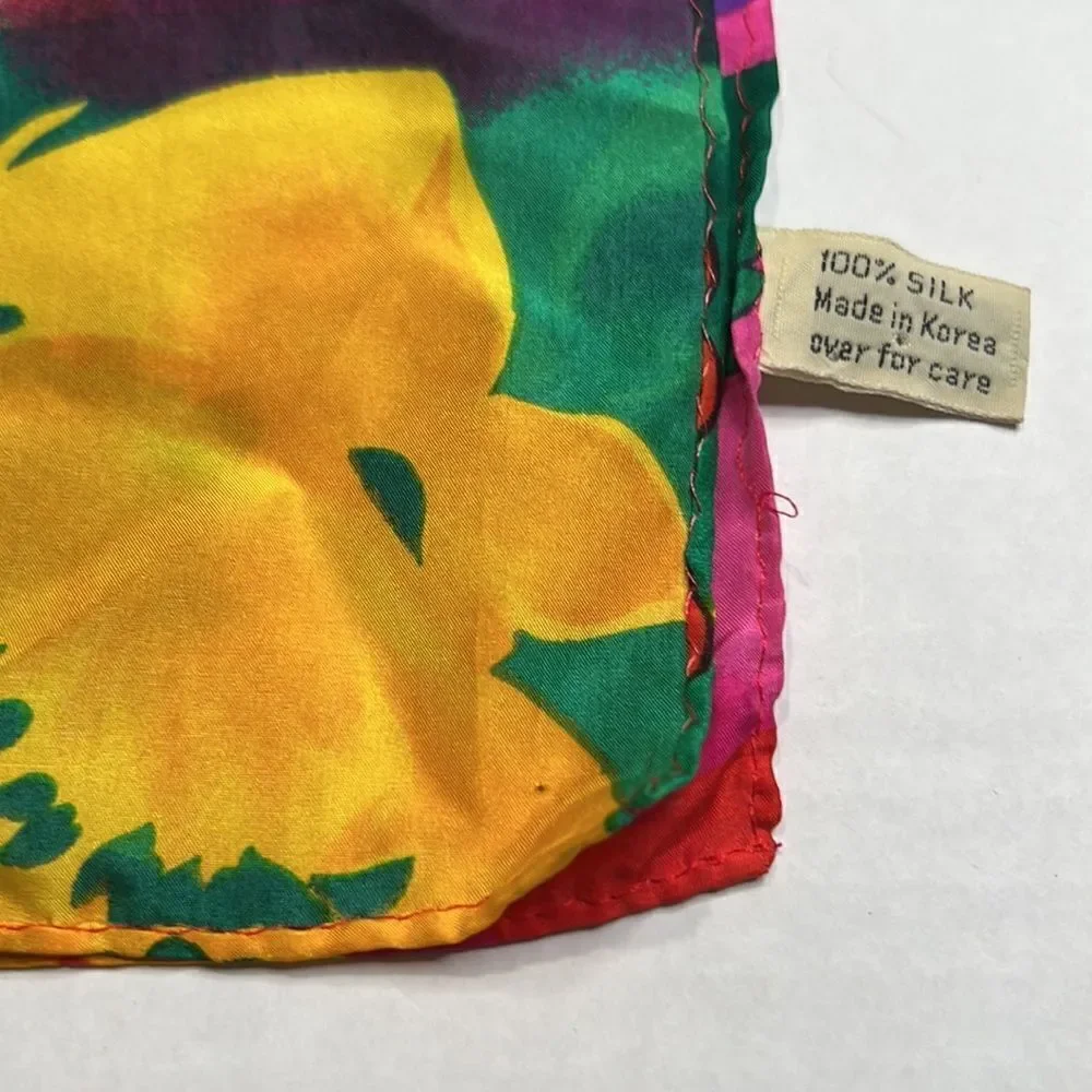 Vibrant floral silk scarf with gold purple pink and red flowers.